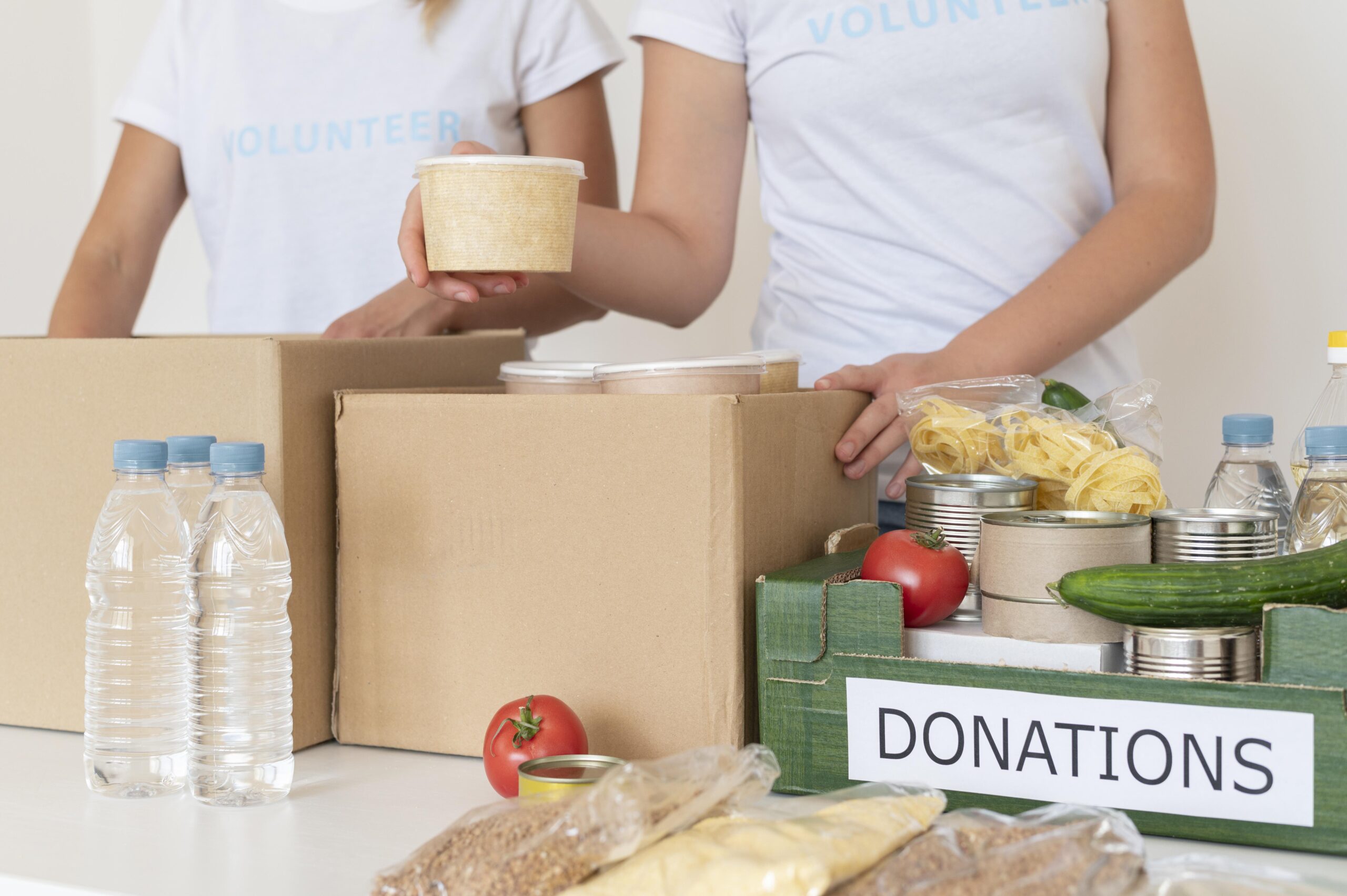 volunteers-filling-box-with-food-donation
